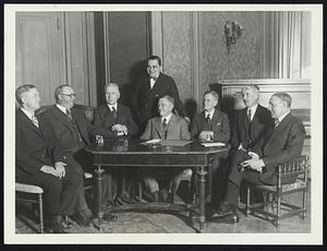 National League Baseball magnates at the Waldorf-Astoria for their schedule meeting. Left to right: Sam Breadon, St. Louis; Wilbert Robinson, Brooklyn; William F. Baker, Philadelphia; John F. Heydler, President of the National League; Barney Dreyfus, Pittsburgh; C.L. McDermott, new President of the Cincinnati Club; and William L. Veech, Chicago. Standing: -- Judge Emil Fuchs, Boston.