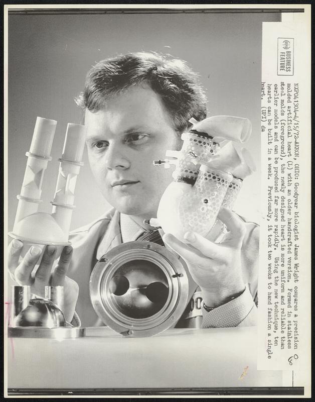 Goodyear biologist James Wright compares a precision molded artificial heart (L) with an older handcrafted version. Formed in stainless steel molds (foreground), the newly designed heart is more uniform and reliable than earlier models and can be produced far more rapidly. Using the new technique, ten hearts can be built in a week. Previously, it took two weeks to hand fashion a single heart.