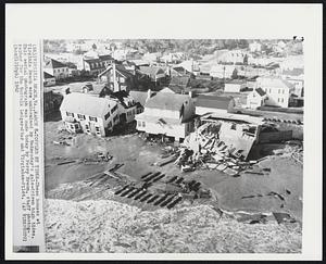 Toppled by Tides-These houses at Virginia Beach were undermined by Wednesday's gale-driven high tides. This aerial photograph was made today by Perry Breon, staff photographer for the Norfolk Ledger-Star and Virginia-Pilot.