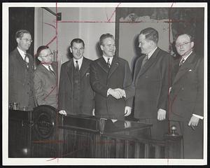 City Councilman John E. Kerrigan of South Boston, third from right, shown receiving the congratulations of his colleagues yesterday following his election as council president for 1944. Left to right are Councilman Maurice H. Sullivan, William F. Hurley, Perlie Dyar Chase, Pres. Kerrigan, Joseph M. Scannell and Thomas G. J. Shannon.