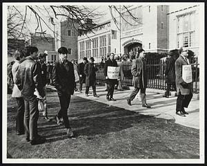 English High Students mill about front of school as teachers picket.