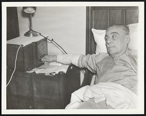Guess What He's Listening To. Col. Jacob Ruppert, owner of the Yankees -- there, it's out-- couldn't attend the World Series games of his champion team, because of illness, but he's been following the Cub-Yank encounters by radio. He's shown in his New York home, Oct. 8, listening to the account of the third encounter between the rival teams at Yankee Stadium.