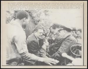 Washington: At least two Vietnam War protestors were dragged away by police 6/17 from near the Supreme Court Building where about a dozen draft cards were burned during a rainstorm. Miss Suzanne Williams, 19, one of the demonstrators, identified the man being arrested here as Frank Femia, of Voluntown, Conn. She said she and Femia on June 4 poured 2 quarts of black paint on draft card at the Customs House in Boston. She said she believed "the FBI took Frank off."