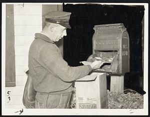 A box full of silt, not letters, confronted the mail man when making his rounds in Ware. He is shown removing the silt, mixed with a small quantity of mail, after the flood has subsided.