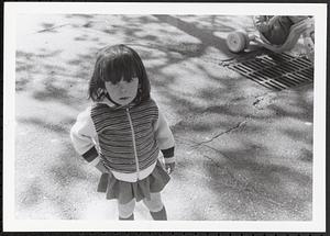 Little girl standing outside