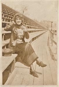 Unidentified woman sitting on bleachers