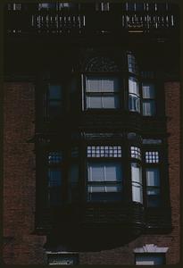 Double bay window on brick wall