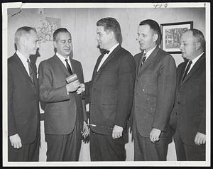 Food Brokers -- Philip Abelson (second from left) new president of the Boston Food Brokers Assn. receives gavel from outgoing president, Edward C. Edwards. Looking on are (left) C. F. Weismann, sec.-treas. and Arthur Sheehan and Paul Alexander, vice presidents.