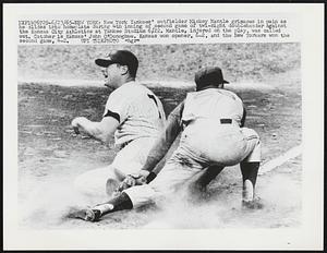 New York Yankees' outfielder Mickey Mantle grimaces in pain as he slides into homeplate during 4th inning of second game of twi-night doubleheader against the Kansas City Athletics at Yankee Stadium 6/22. Mantle, injured on the play, was called out. Catcher is Kansas' John O'Donoghue. Kansas won opener, 6-2, and the New Yorkers won the second game, 4-2.