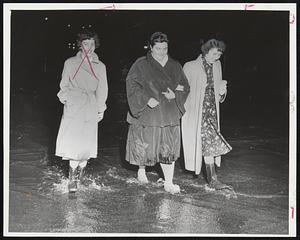Paddling Through Puddles-Lee Hoye (left) and Jerry Milton, both of Peabody, had to put on rubber boots when they went for a walk on Main St. after the flood.