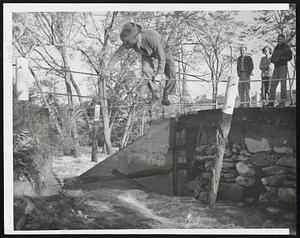 Dangerous Crossing__ The Bridge on Route 9 over Burr Brook Was One of the Casualties of Hurricane Flood Waters in Storm Battered Maine. The Bridge at North Brewer, Was on Short Route Between Calais and Bangor. An Unidentified Man is Shown Crossing on the Bridge Guard Rail.