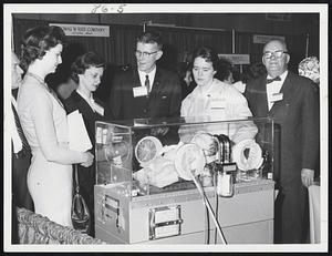 "Isolette" - Controlled heat - humidity, oxygen + rocking motion for artificial respiration for premature babies - l to r. - Jane Callanan - Warren, R.I. Judy Campbell - Brockton - H. L. Crowley - Crowley + Gardner Co. - Boston Jeanne Hannigan - Brockton Henry Paulsen - Crowley + Gardner Co. - Bos.