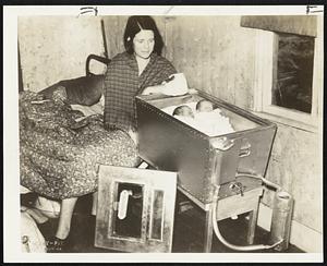 Portable Incubator to Save Babies - A kerosene burning incubator costing $50 which is being tried out by the Maryland health department. Invented by Dr. Daniel Fisher of Salisbury, Md., it is expected to lower rural infant mortality rates. Mrs. Irma Griffin of Salisbury finds the device a perfect crib for her twins.