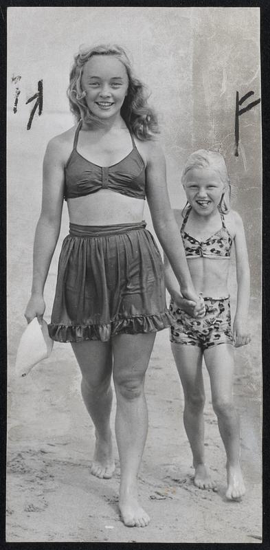Two Polio Victims-Marjorie Gleed, 15, Haverhill, and Judith Tettler, 8, North Andover, stroll on the sands at the Plum Island Camp for victims of infantile paralysis.