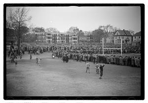 Crowd surrounding a football field