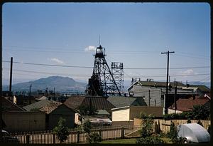 Group of buildings and mine head frames with mountains in background, Butte, Montana