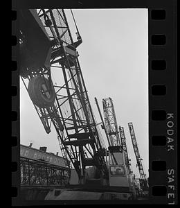 Folded construction cranes in storage yard, Everett