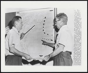 Storm Forecasters at Work -- Gordon Dunn, left, chief forecaster in the weather bureau's storm warning service, discusses with Cecil Gentry, right, where they expect to hoist hurricane warnings along the Georgia or Carolina coast as Tropical Hurricane Diane whirls its 115-mile winds toward shore. The alerted area is marked. The path of last week's hurricane, Connie, also is shown.