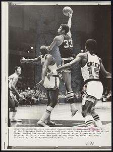 Alcindor Scores--Lew Alcindor (33) of the Milwaukee Bucks tries a hook shot over Luke Jackson of the Phila-76ers during the second quarter of Tuesday night's game in Philadelphia. Alcindor's shot was good as the Bucks defeated the 76ers, 122 to 114.