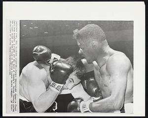 Close Quarters-- Former heavyweight champion Floyd Patterson bounces a right off the head of Canada's George Chuvalo during the first round of their bout at Madison Square Garden tonight.