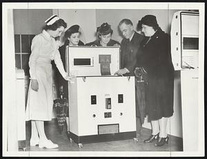 Latest Type Incubator--for premature babies is explained to Mrs. Mae Collins, Mrs. Cornelius T. O'Connor, and Mrs. Margaret G. Reardon by Nurse Margaret Twoomey and Dr. Phillip McGovern at the public open house the Cahill House, new maternity building at the Cambridge City Hospital.