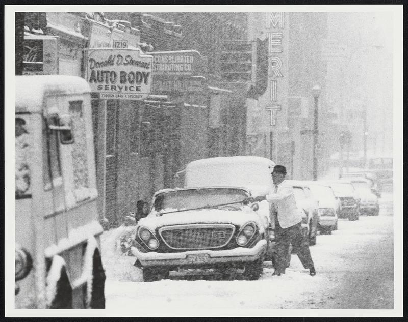 Clean that windshield of your car. Tremont St., Roxbury. Weather storms snow