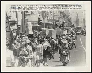 Vanguard of an estimated 4,000 anti-Vietnam war demonstrators parade down Market St, protesting U.S. participation in the conflict. At R. backgd is the Ferry Bldg. Note girl in Oriental costume (R-C), acting as a monitor for marchers, aboard motorcycle.