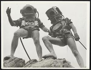 Four Legs Under Sea. Among the occupations they list at Manly, Sydney, New South Wales, is underwater rock shifting, and divers wearing these curious helmets, but bare-legged and bare-armed, go traipsing about in shallow water shifting rocks. The personage on the left, Charles Edwards, met up with a seven foot shark on a recent job. The shark knocked him over.