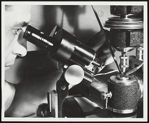 Diminutive Drill -- Peering through a microscope, a General Electric instrument maker brushes away minute chips left by a one-mil (.001-inch) drill too small to be seen by the naked eye. To show the effectiveness of the tiny drill, GE precision instrument makers have not only split human hairs, but have drilled holes in hair and threaded one-thousandth of an inch wire through the holes. The drill is used in the company's General Engineering Laboratory for such functions as drilling fuel nozzles, leak orifices and X-ray apertures.