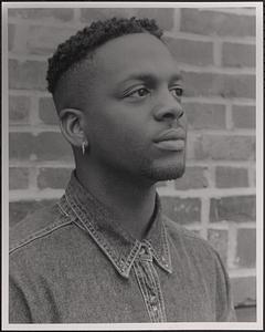 Portrait of Irv, seen in profile in front of a brick wall