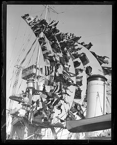 USS Milwaukee in Navy Yard with pennants flying