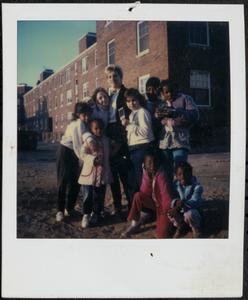 Group posing with photographs in Newtowne Court