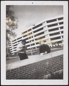 Two people outside parking garage