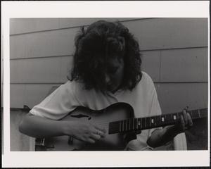 Young woman playing the guitar