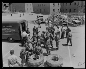 Group of military personnel standing beside a New England Emergency Provincial Headquarters truck