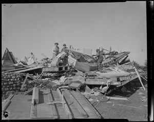 Group of people standing on wreckage pile