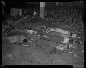 Group of people lying on cots