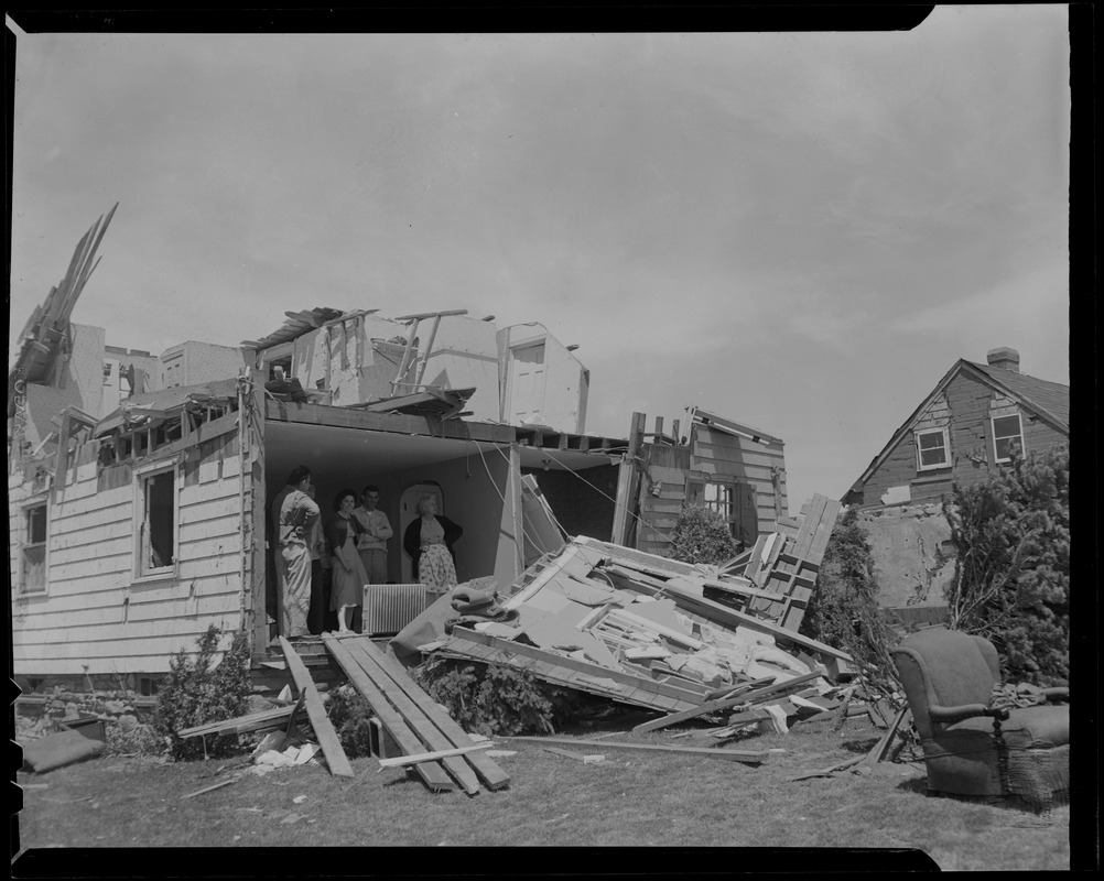 House missing exterior wall, showing people in a room, looking out at ...