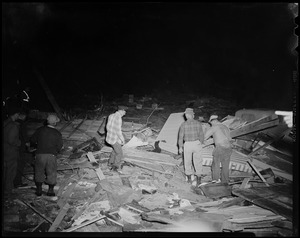 Men assessing wreckage from tornado