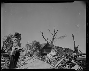 Person looking over wreckage of building destroyed by tornado