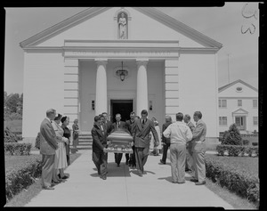 Pallbearers carrying coffin out of church