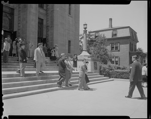 People walking out of a church, most likely for a funeral