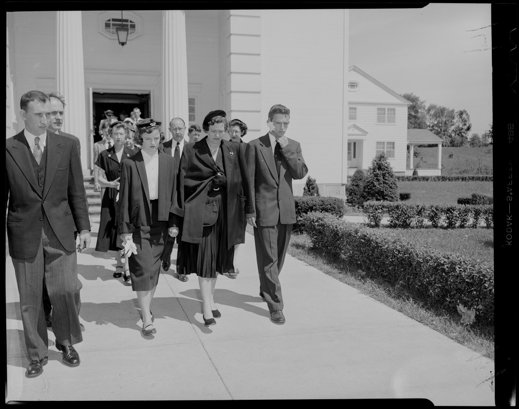 People walking out of church, most likely for a funeral