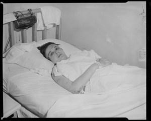 Wounded person lying in bed