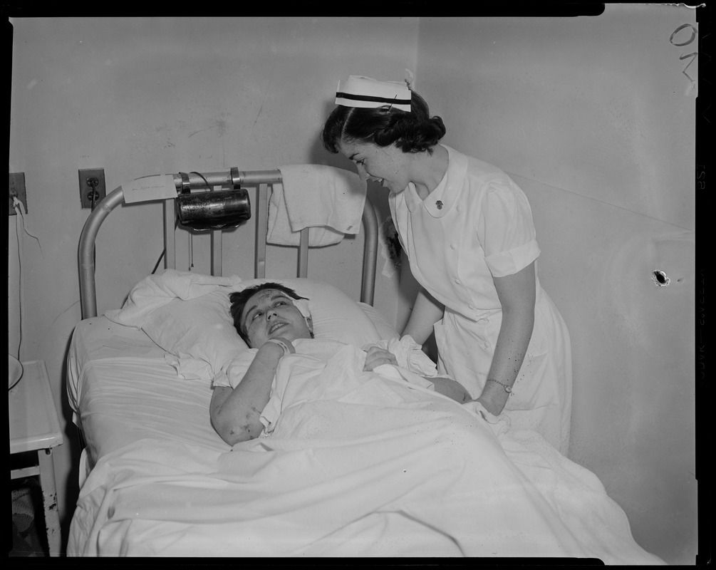 Nurse attending to patient in bed - Digital Commonwealth