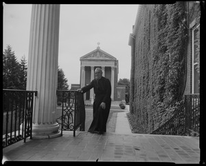 Fr. Joseph T. O'Callahan standing on stairs near St. Joseph Memorial Chapel at College of the Holy Cross