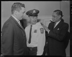 Getting an autograph from Indian ambassador B. K. Nehru is police officer Roy Covell of Readville who lends his back for the writing