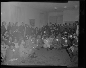 Large group, possibly members of the Hindustan Students' Association of Greater Boston, some sitting on the floor and others standing
