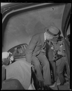 Jawaharlal Nehru entering vehicle with photographer behind him