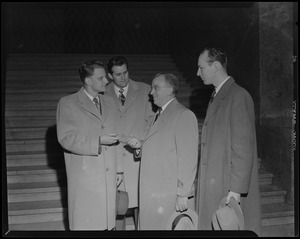Billy Graham, far left, in conversation with three men and holding a ceremonial key
